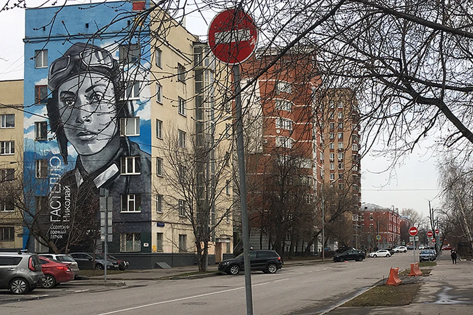 В глаза бросается портрет легендарного лётчика на торце шестиэтажки. И вдоль дороги - белые кирпичики