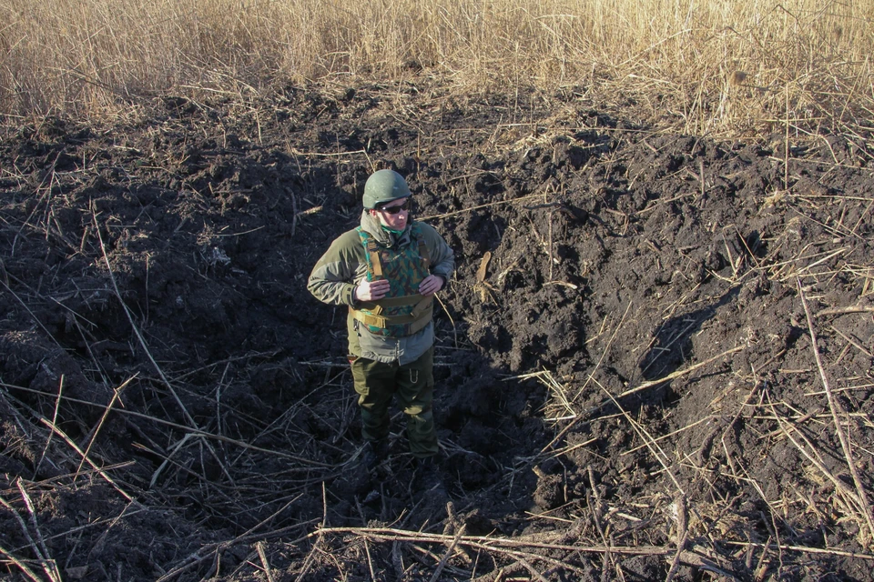 После обстрела поселка воронки остались в человеческий рост (на фото корреспондент «Комсомольской правды»)