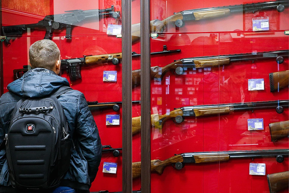 Посетитель у витрины оружейного магазина. Фото: Валерий Матыцин/ТАСС
