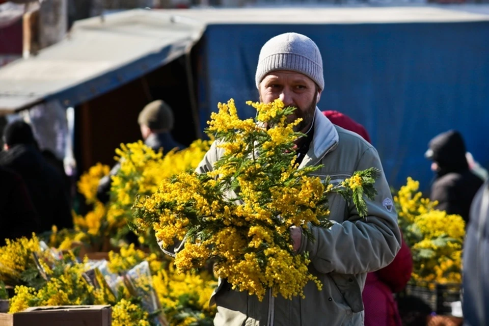 Букет мимозы в руках мужчины